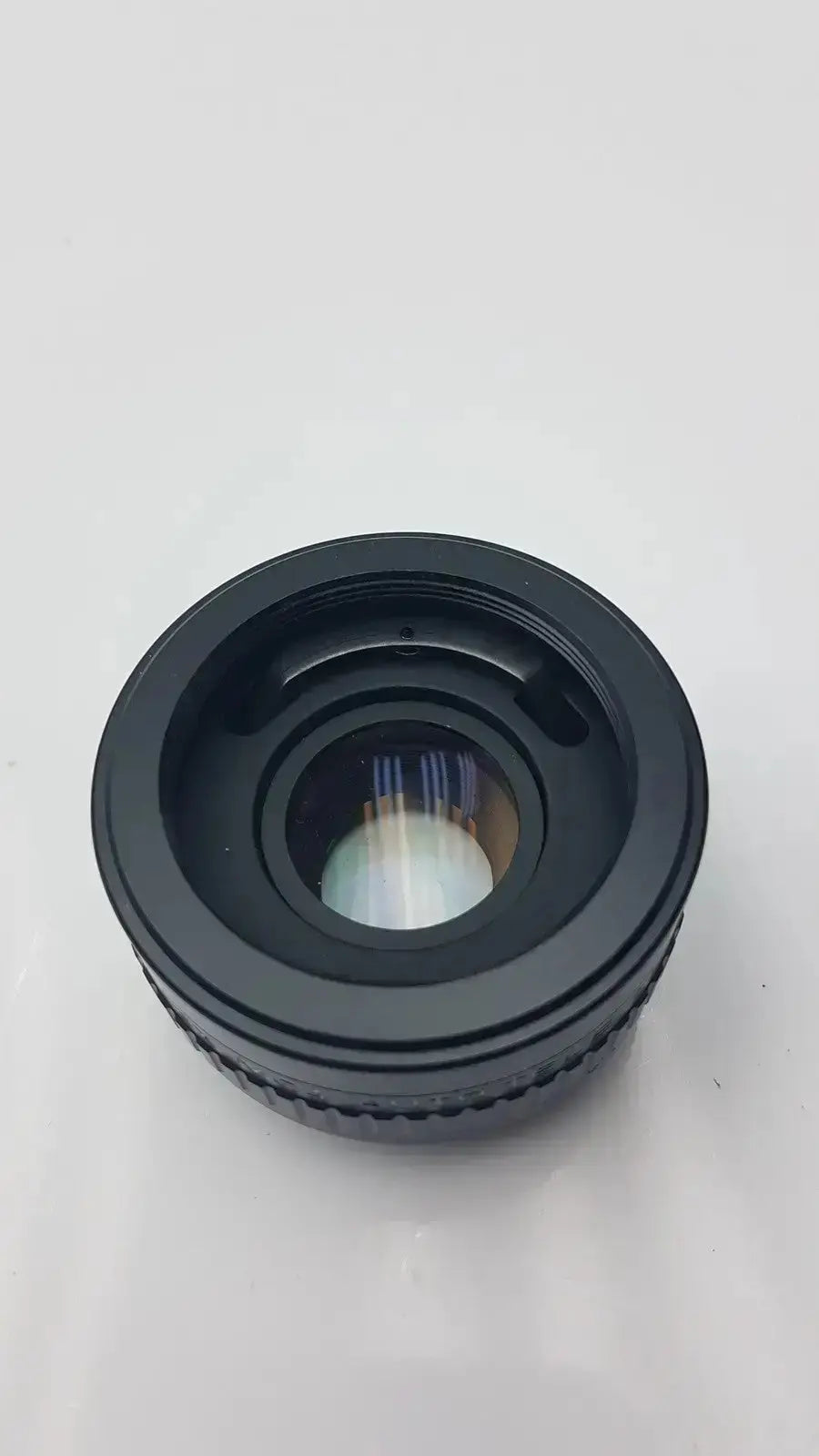 Black circular rokunar 2x mc4 auto tele converter lens adapter with textured ridges and reflective glass element