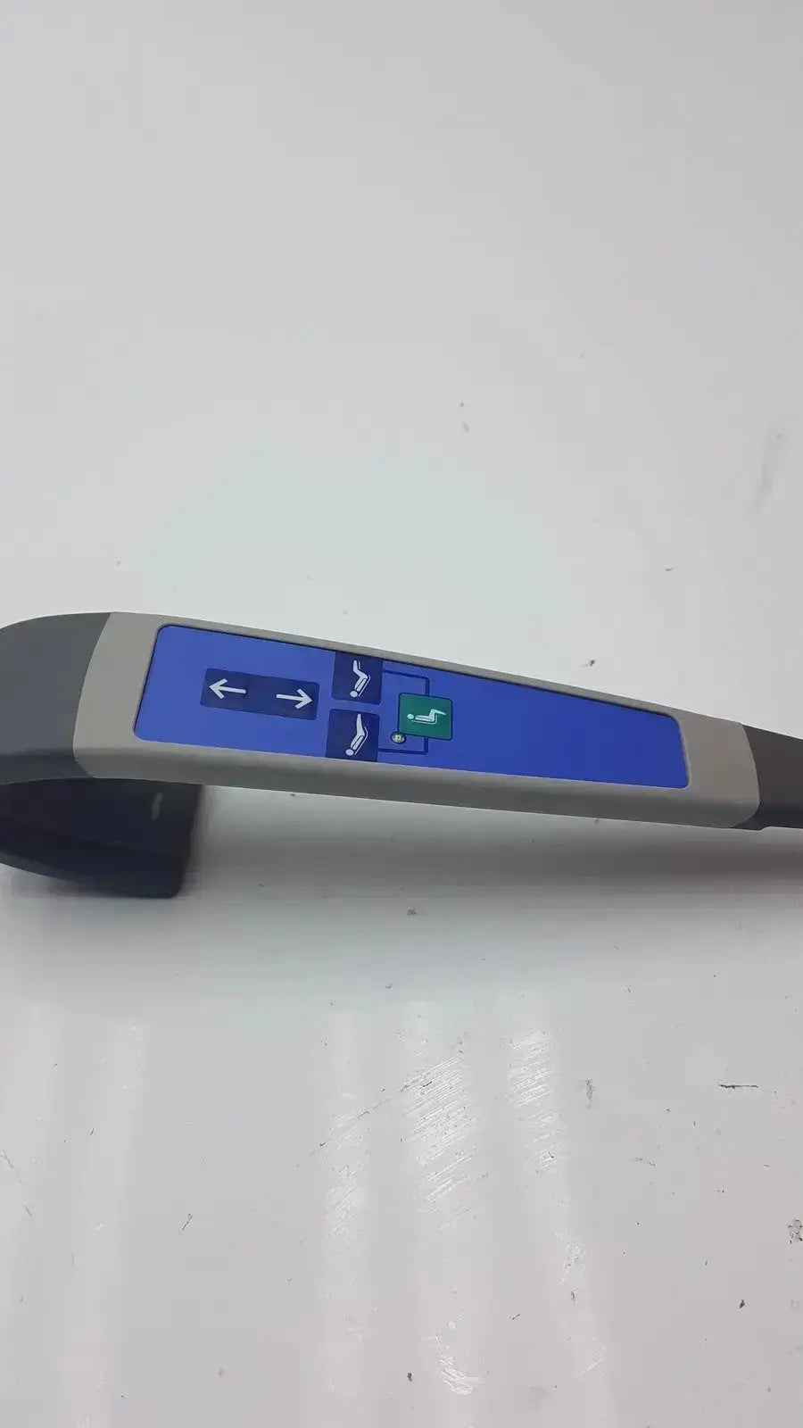 Gray and blue handheld arjo huntleigh carendo remote with directional arrows and green button for shower hygiene chair control
