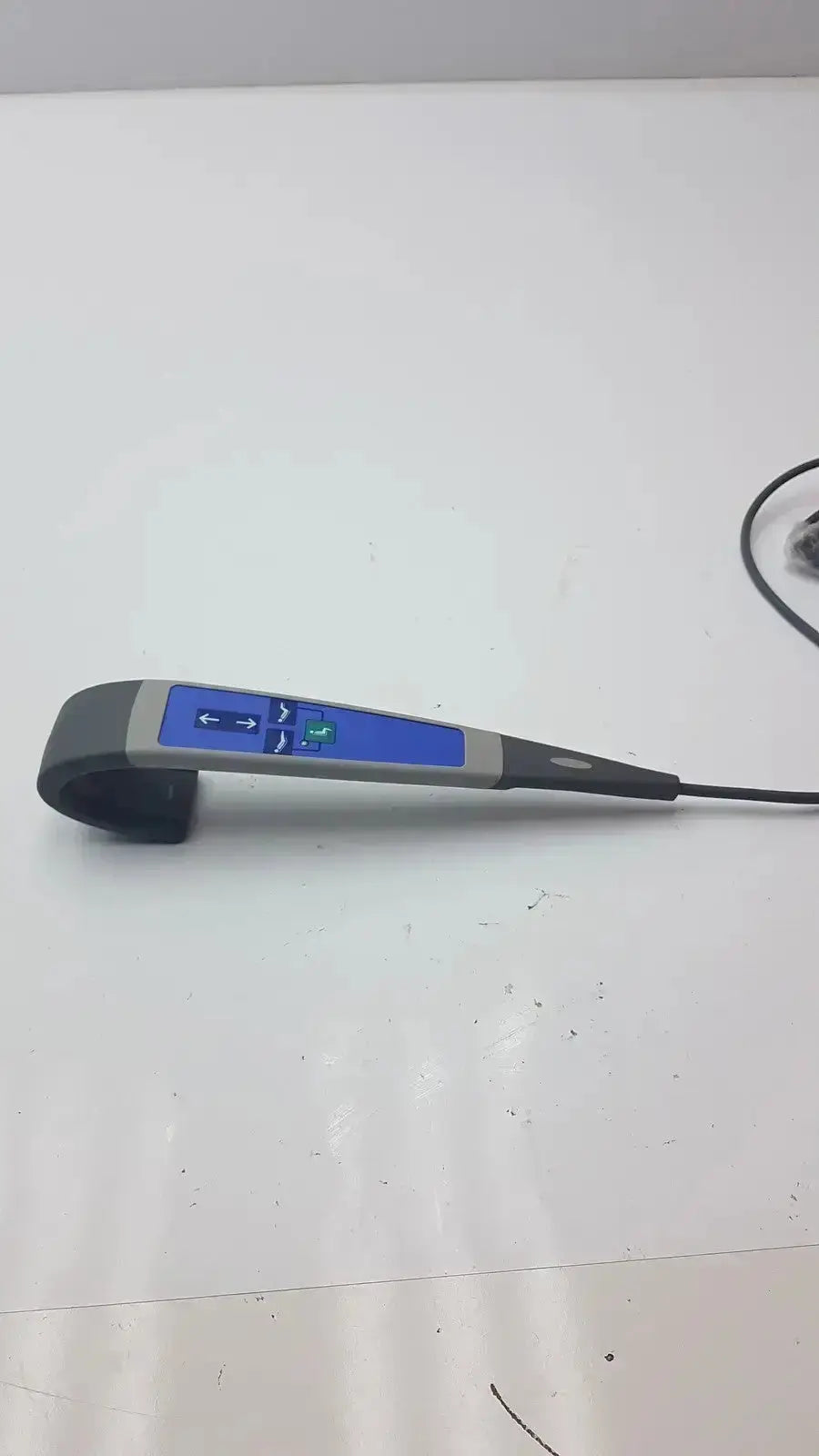 Gray and blue handheld arjo huntleigh carendo remote with curved black grip and illuminated display for shower hygiene chair