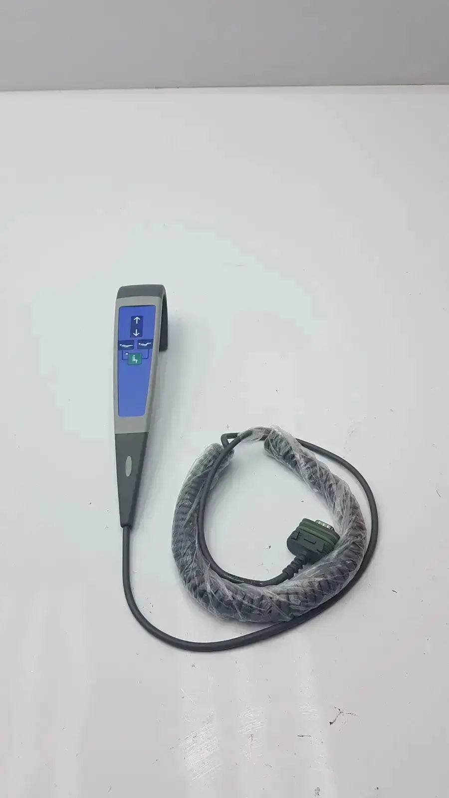 Gray and blue arjo huntleigh carendo remote with coiled black cable in clear plastic for shower hygiene chair 5 function