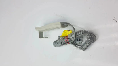 Gray coiled cable with beige-handled arjo huntleigh patient lift remote handset featuring yellow label and red tie