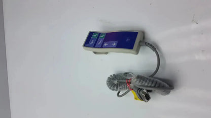 Gray Arjo Huntleigh patient lift remote handheld device with blue control panel and coiled cable with d-sub connector