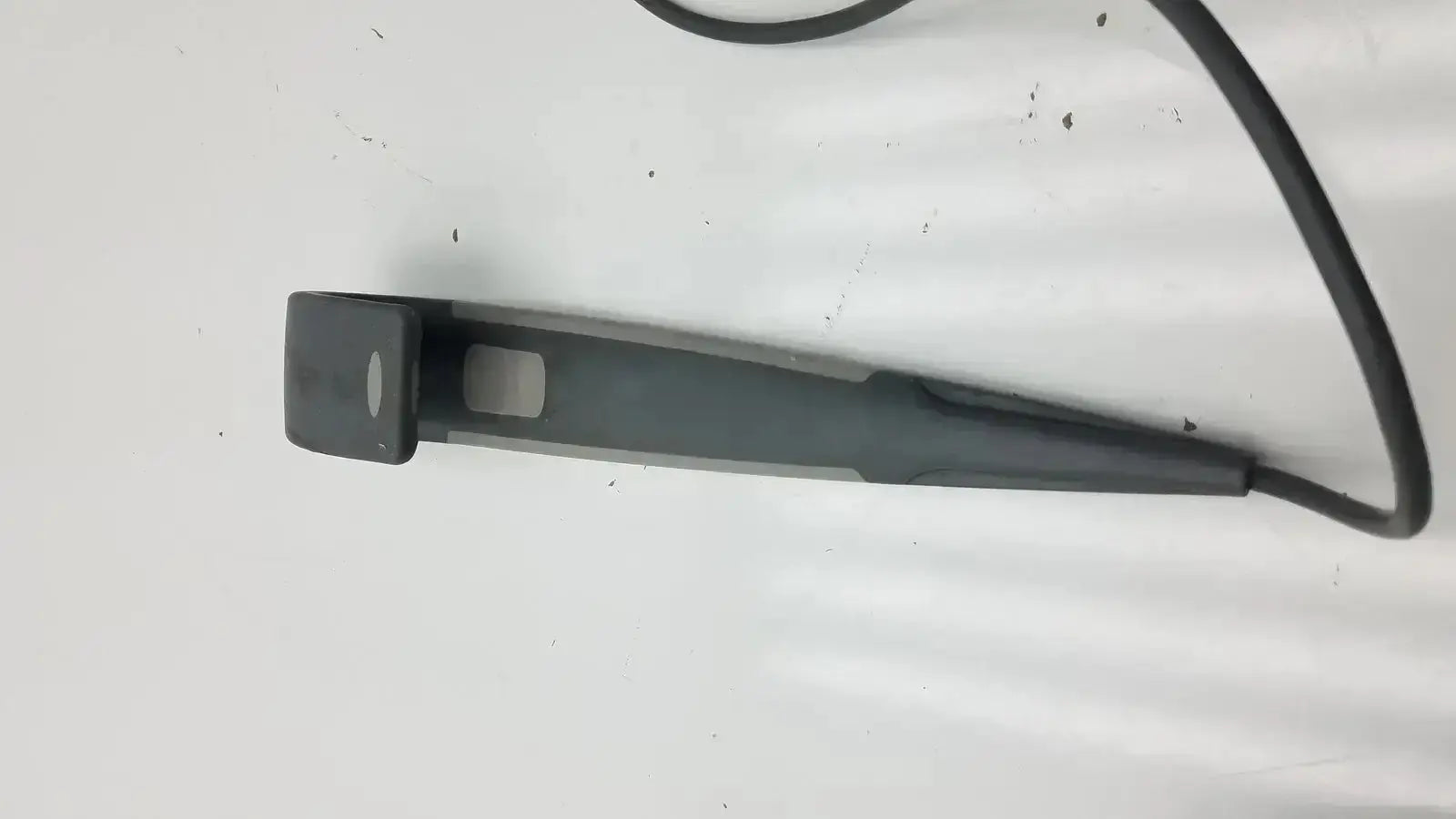 Black plastic car windshield wiper blade with curved handle and cord for arjo huntleigh patient lift wired remote handset controller