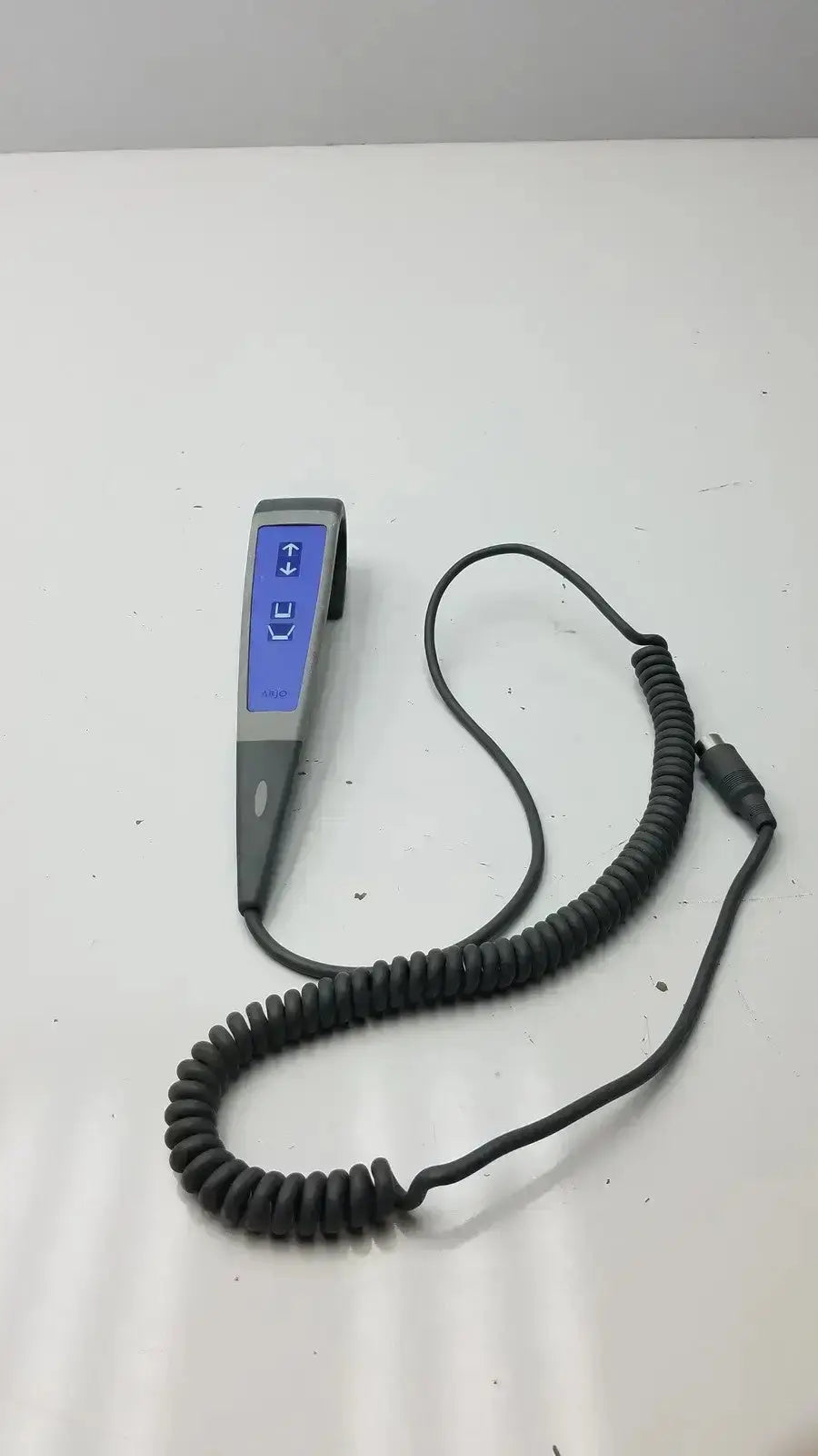 Gray arjo huntleigh patient lift wired remote handset controller with blue illuminated buttons and coiled cable