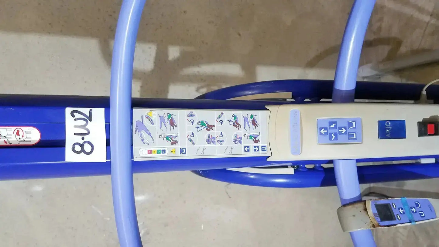 Blue hospital bed with control panel and instructional diagrams on the arjo maxi power patient lift handset 700-19326