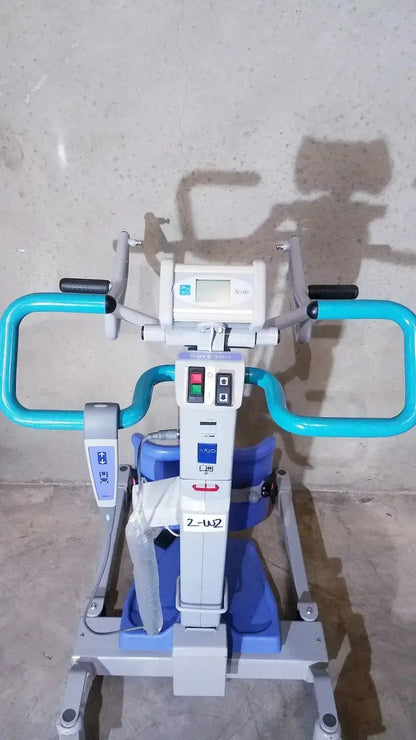 Blue and white arjo sara 3000 hospital mobile patient lift chair with control panel and handlebars for standing raising aid
