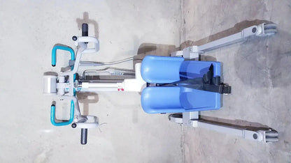 Blue and white arjo sara 3000 hospital mobile patient standing raising lift aid with teal handlebars for safe patient support