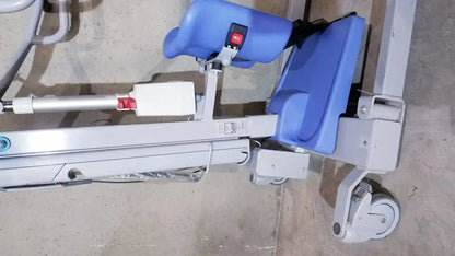 Blue padded arjo sara 3000 hospital mobile patient standing raising lift aid with gray metal frame and wheels
