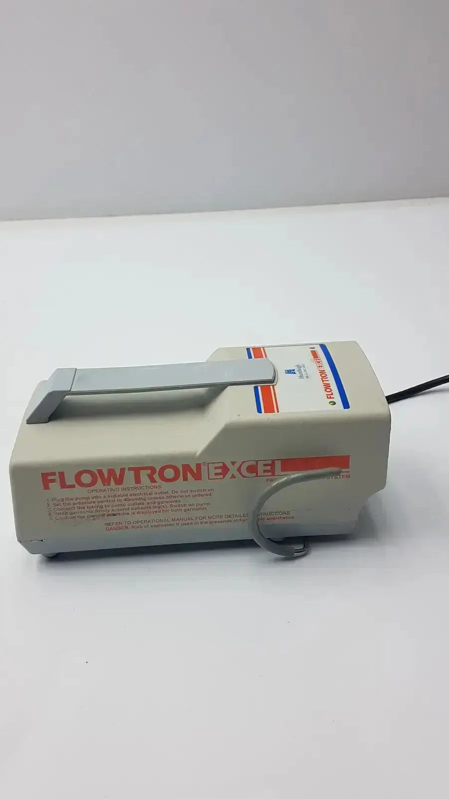 Beige plastic arjohuntleigh flowtron excel medical device with gray handle and red blue branding stripes model ac 550