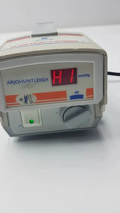 Beige arjohuntleigh flowtron excel model ac 550 blood pressure monitor with red digital display and green power indicator
