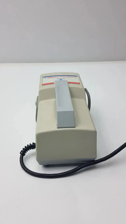 Beige plastic handheld arjohuntleigh flowtron excel model ac 550 with gray handle and black coiled cord