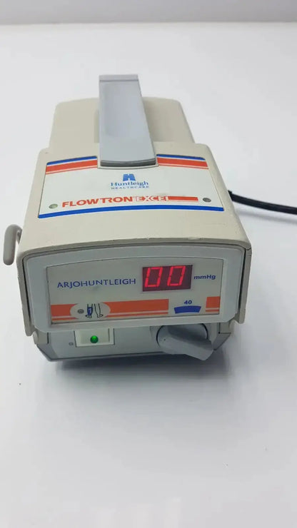 Beige plastic arjohuntleigh flowtron excel medical infusion pump with red digital display and orange-blue stripes