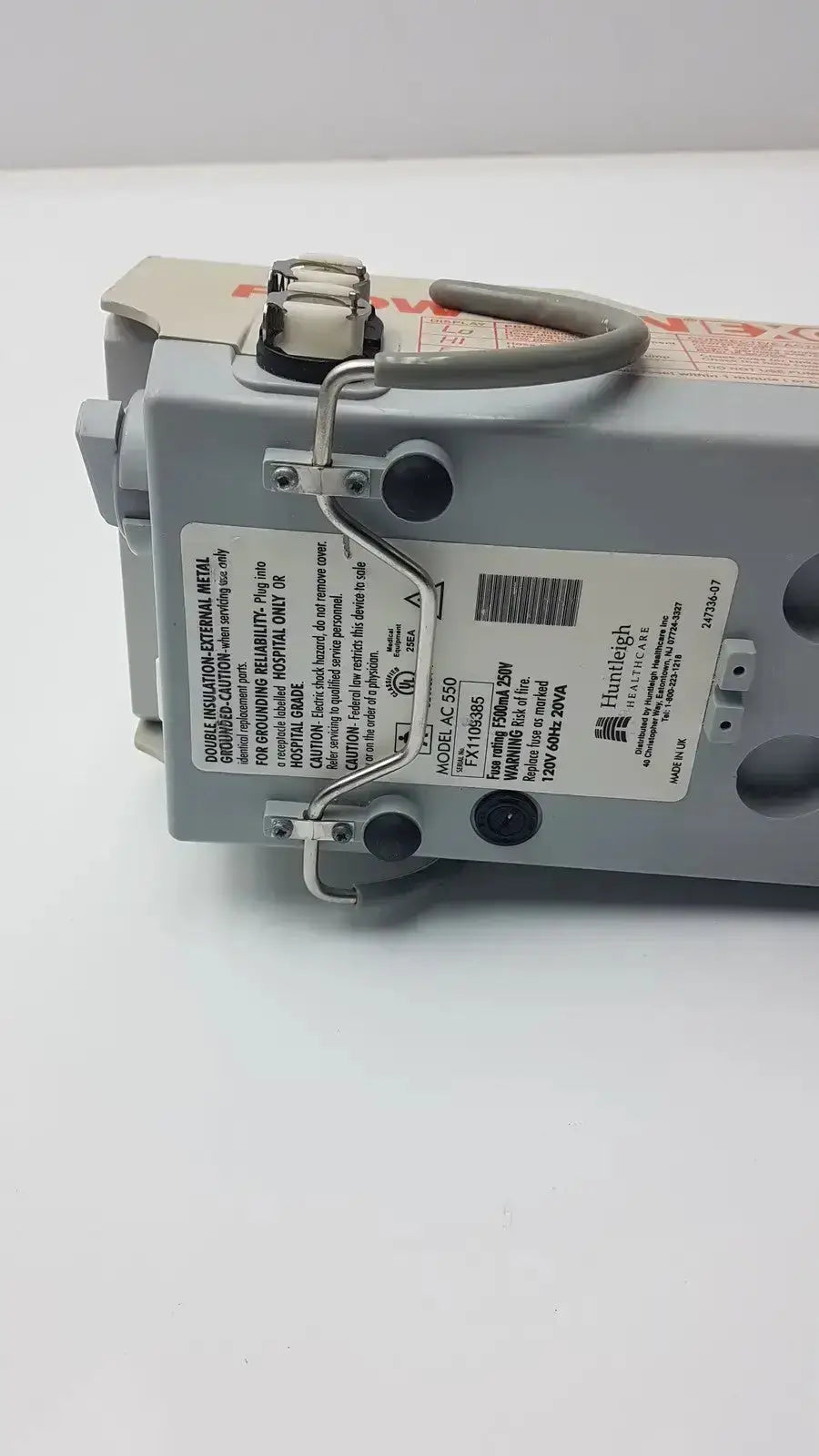 Gray plastic electrical panel with metal brackets and handle labeled huntleigh for arjohuntleigh flowtron excel ac 550