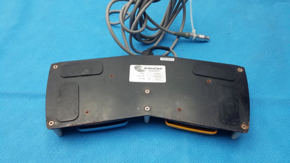 Arthrocare 10863 dual footswitch pedal in black with coiled gray cable and yellow accents for pre owned medical equipment sale