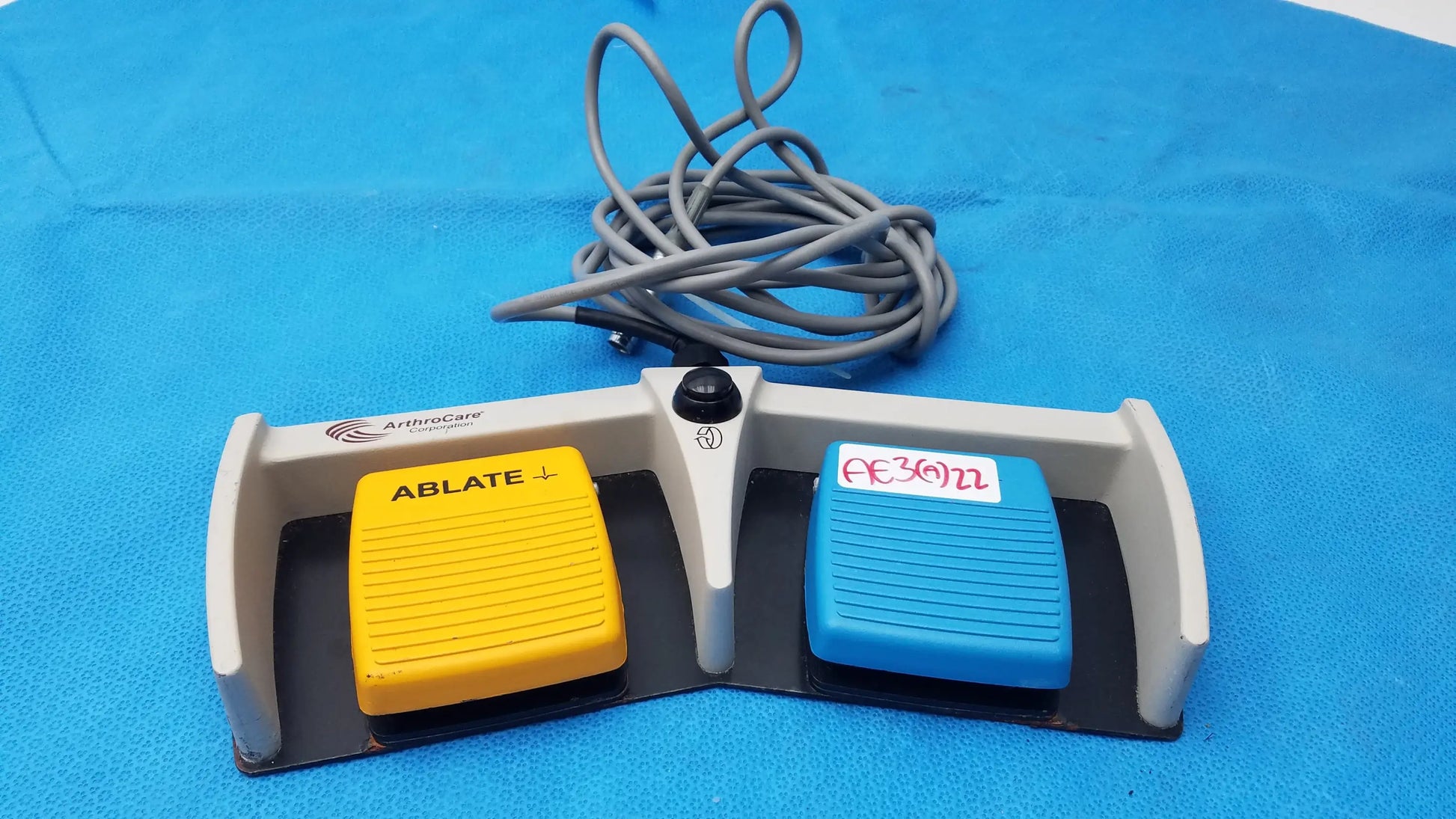 Gray and black arthrocare 10863 dual footswitch pedal with yellow ablate and blue ac3074 buttons for buy used medical equipment