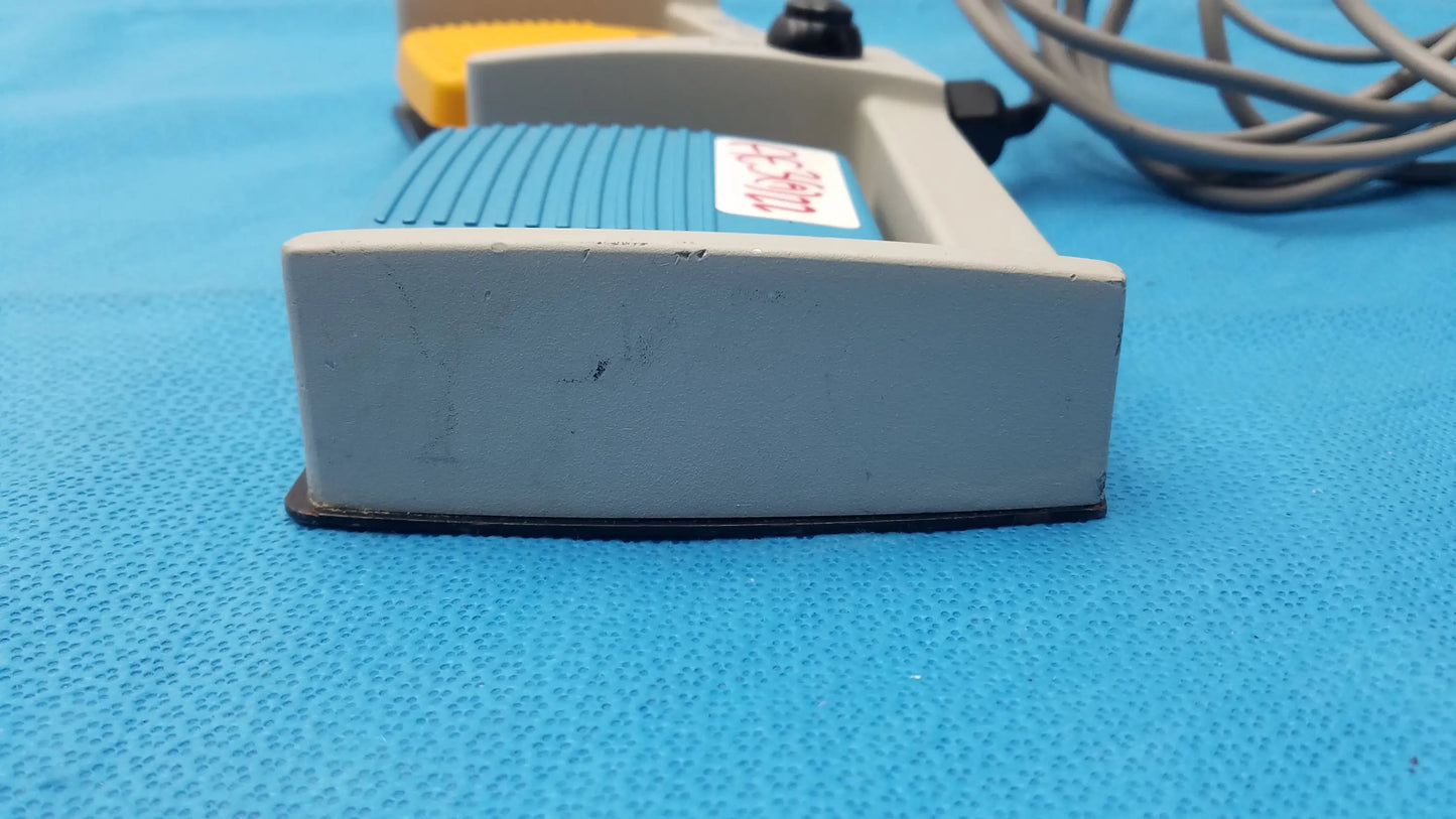 Gray plastic arthrocare 10863 dual footswitch pedal with blue grip and yellow accents for buy used medical equipment