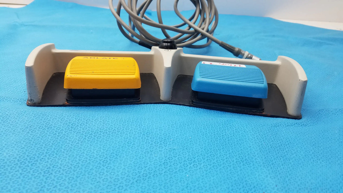 Gray plastic arthrocare 10863 dual footswitch pedal with yellow and blue buttons connected by coiled cable for medical use buy used medical equipment