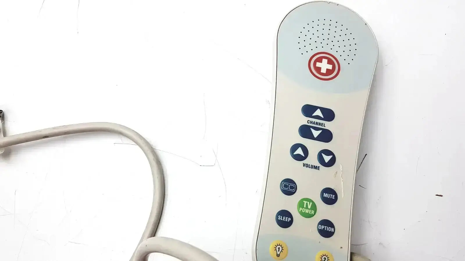 Beige ascom hc-pspkr-da-d2 patient response remote control with red cross, blue and green buttons, and top speaker grille