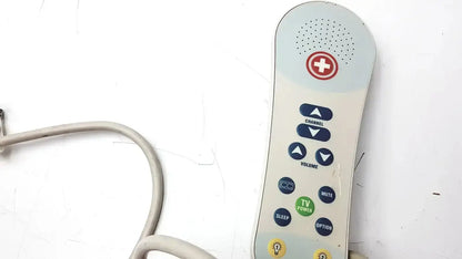 Beige ascom hc-pspkr-da-d2 patient response remote control with red cross, blue and green buttons, and top speaker grille