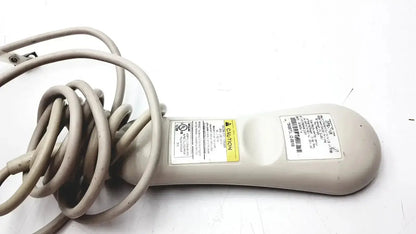 Beige plastic-handled electric hair dryer with coiled gray cord and warning labels for hc-pspkr-da-d2 patient response system
