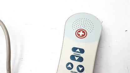 White and light blue Ascom hc-pspkr-da-d2 patient response medical alert remote with red cross and volume controls