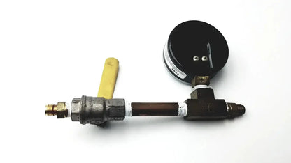 Black ashcroft dual-scale pressure gauge 0 to 200 psi and 0 to 1400 kpa mounted on metallic pipe with brass fittings and yellow handle for pre owned medical equipment sale