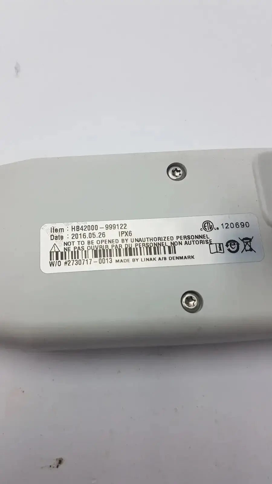 Light gray plastic back side of atlas hb42000-999122 handset with white label showing ipx6 rating and date 2016.05.26