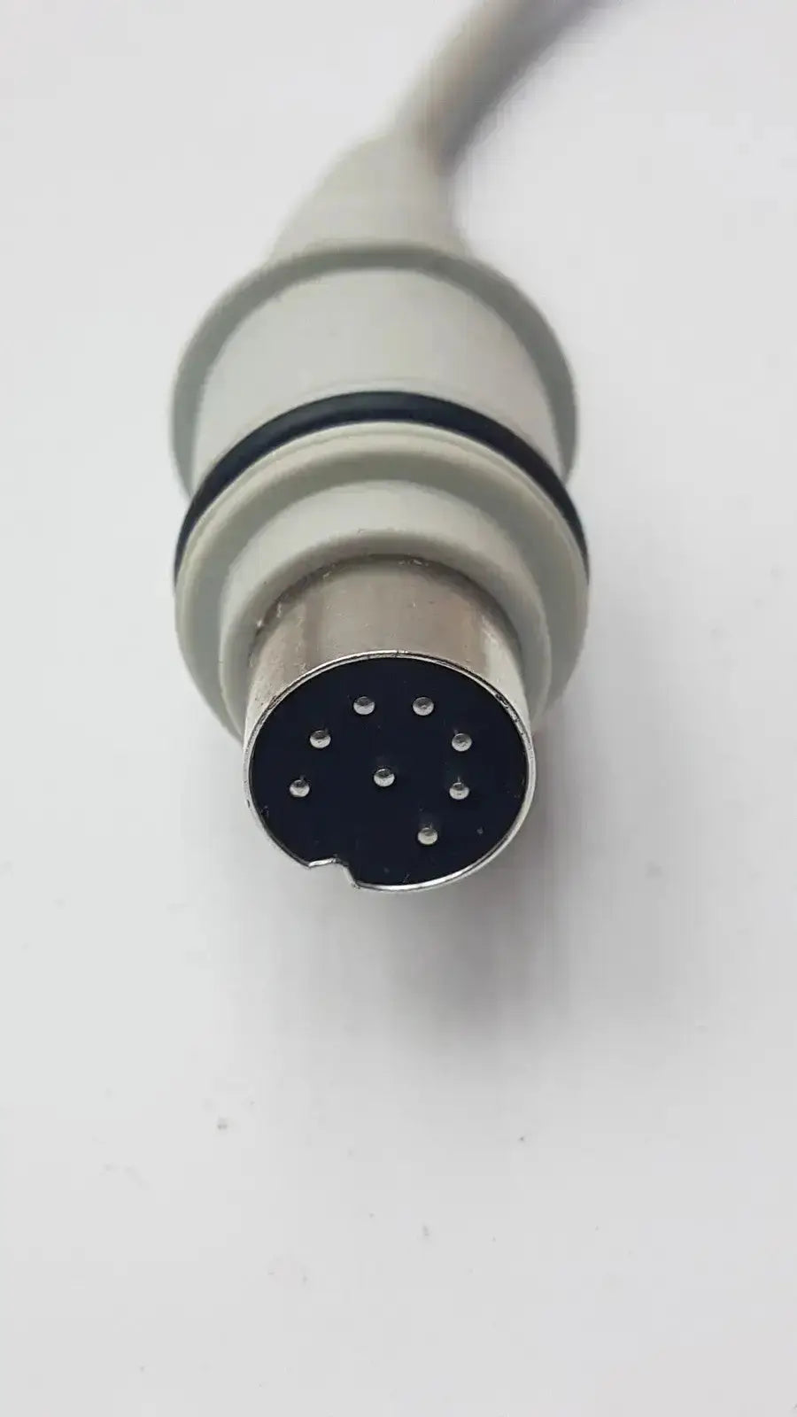 Gray and black 15-pin medical-grade connector with metallic housing on the back of atlas hb42000-999122 handset