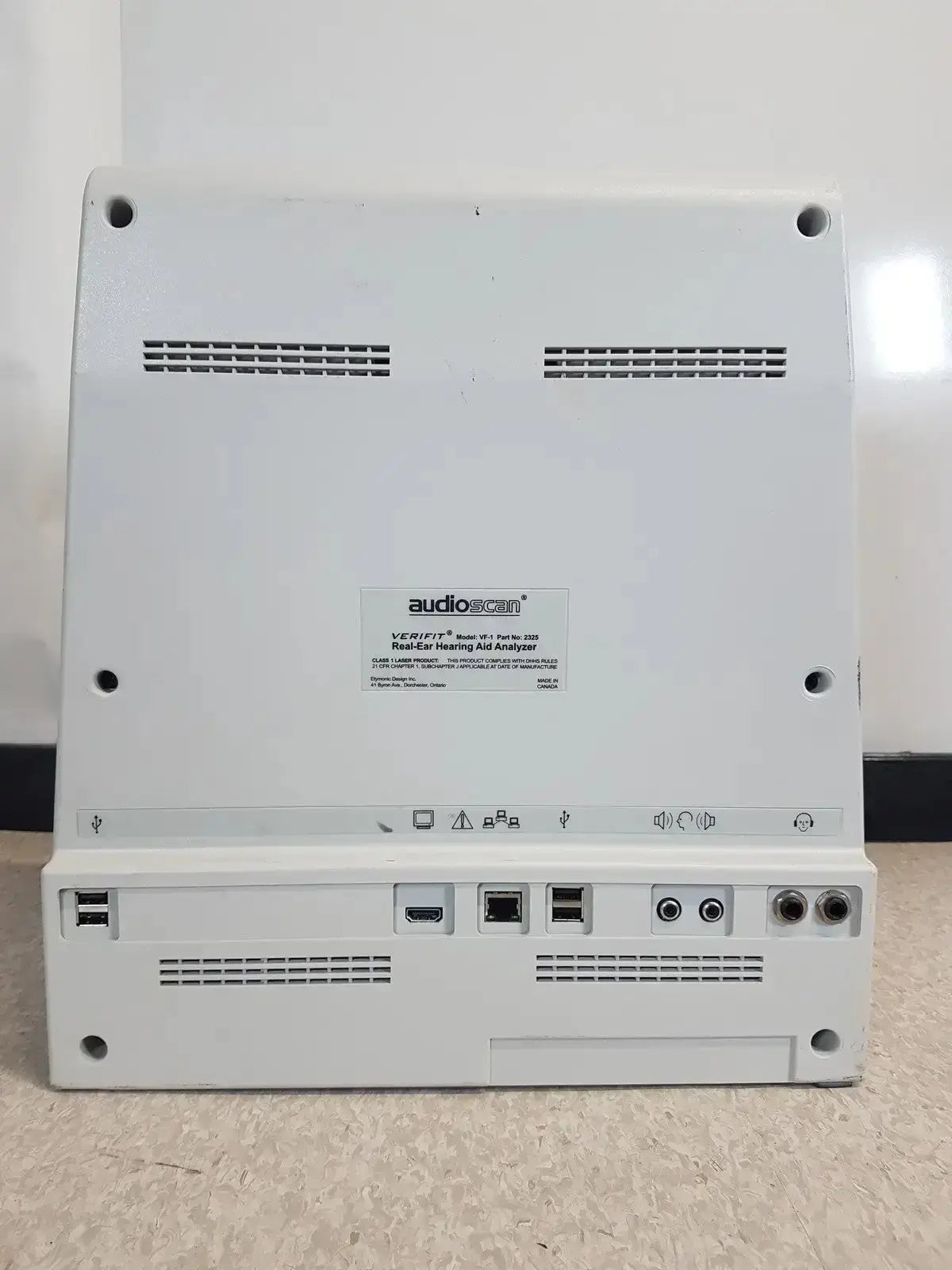 Back panel of white audioscan verifit vf-1 hearing aid analyzer with multiple ports and ventilation slots
