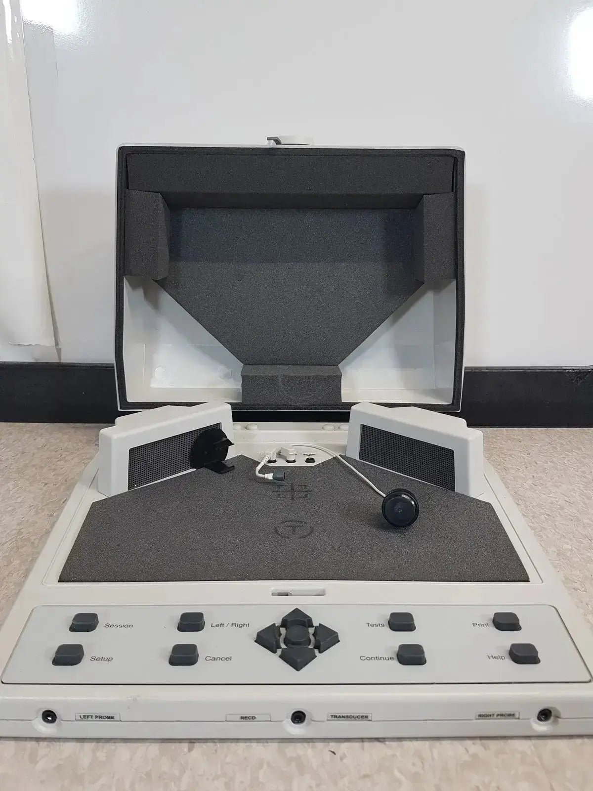 White plastic audioscan verifit vf-1 hearing aid analyzer with black buttons, directional pad, speakers, and foam-lined lid open