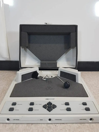 White plastic audioscan verifit vf-1 hearing aid analyzer with black buttons, directional pad, speakers, and foam-lined lid open