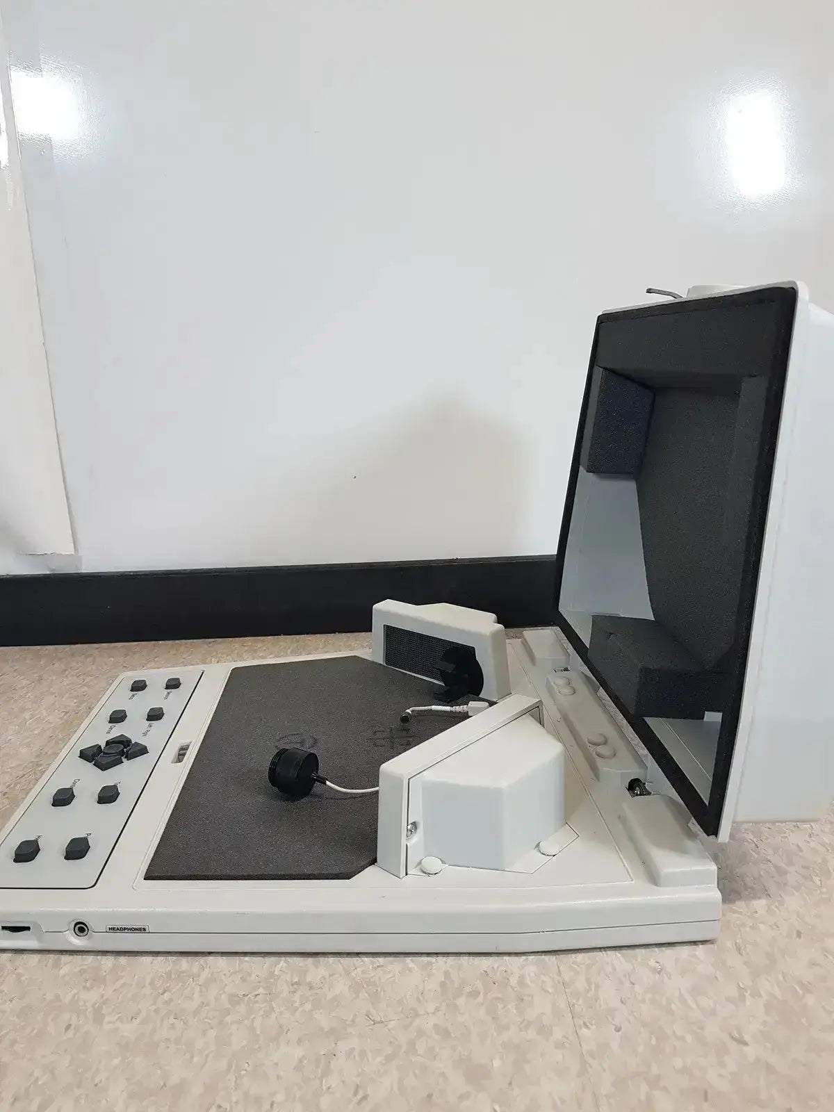 White digital microscope with black screen and gray scanning platform on audioscan verifit vf-1 hearing aid analyzer