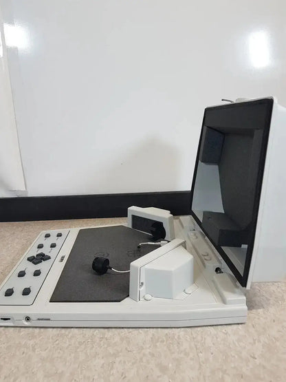 White digital microscope with black screen and gray scanning platform on audioscan verifit vf-1 hearing aid analyzer