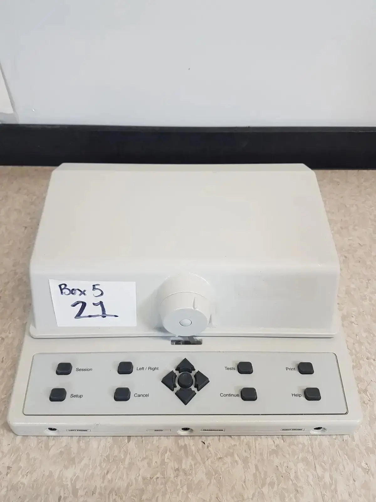 White plastic audioscan verifit vf-1 hearing aid analyzer with black buttons and central directional pad model 2325