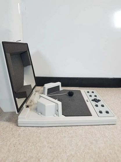 White and gray audioscan verifit vf-1 hearing aid analyzer with black screen and control panel on flat surface