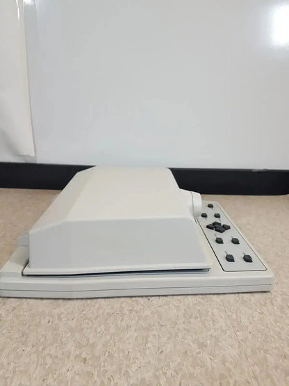 White plastic desktop audioscan verifit vf-1 hearing aid analyzer with rectangular lid and black control buttons on right side