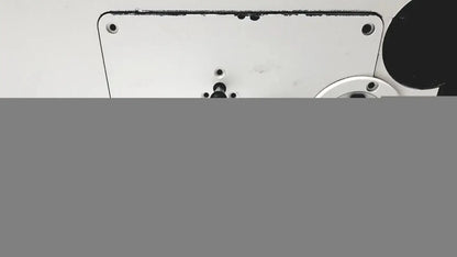 White metal plate with screws and central hole on the back side of the Axiovert 35 inverted phase contrast microscope