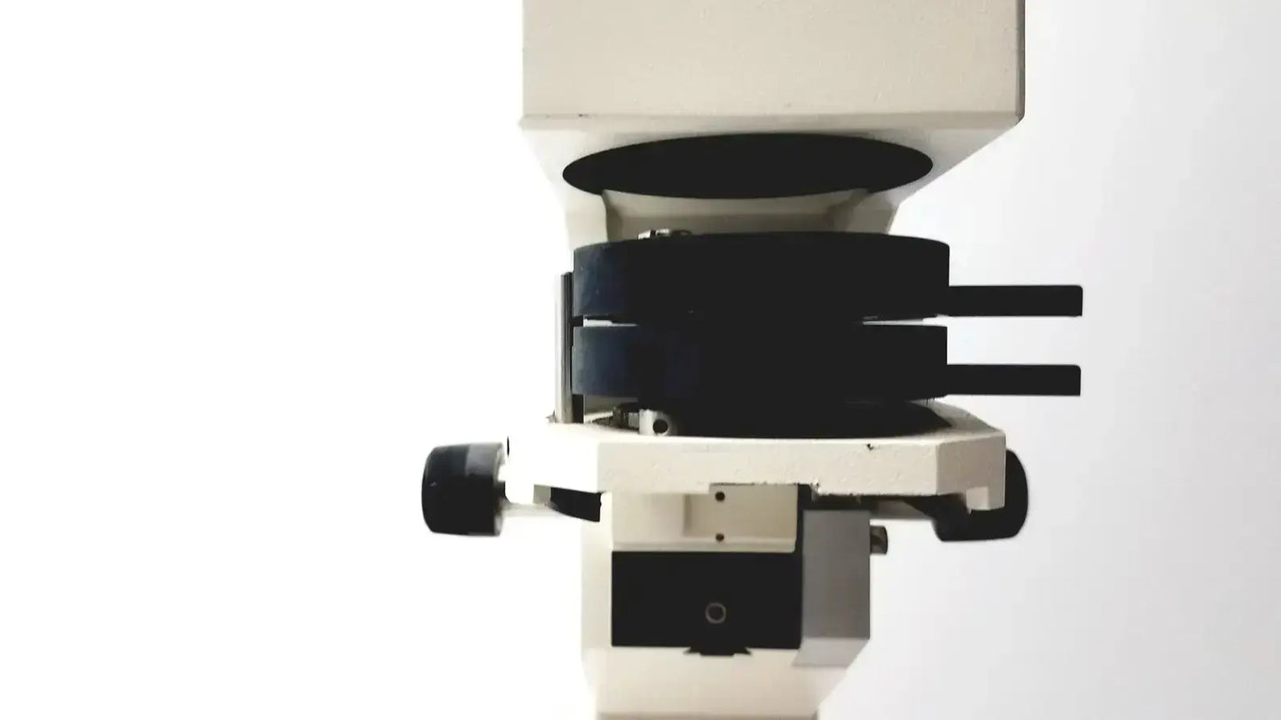 Axiovert 35 inverted phase contrast microscope with white and black body and rotating stage holding multiple lenses