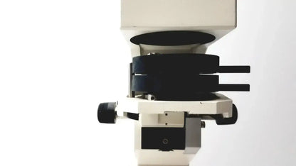 Axiovert 35 inverted phase contrast microscope with white and black body and rotating stage holding multiple lenses