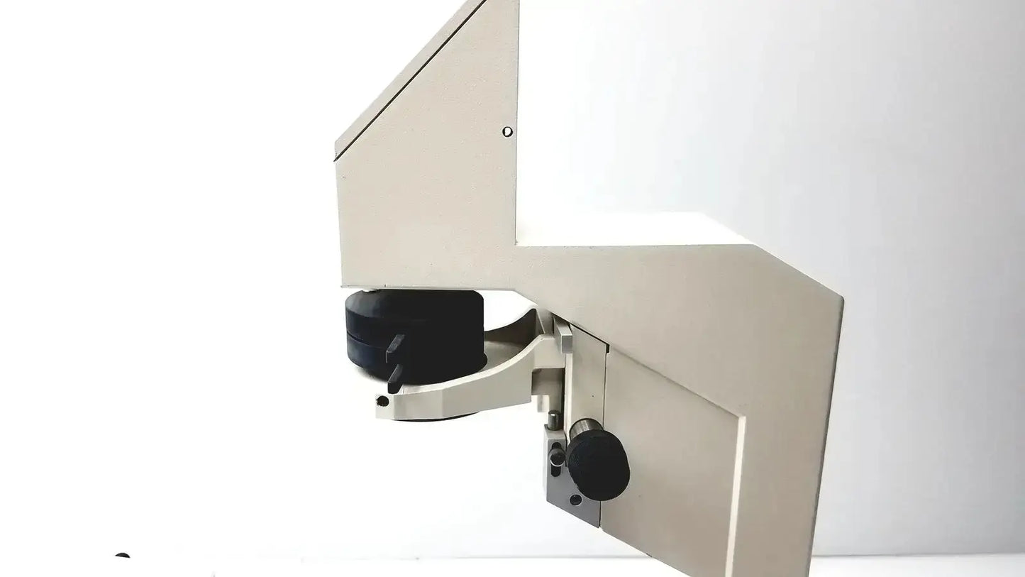 Beige metallic axiovert 35 inverted phase contrast microscope with black circular stage and adjustment knobs