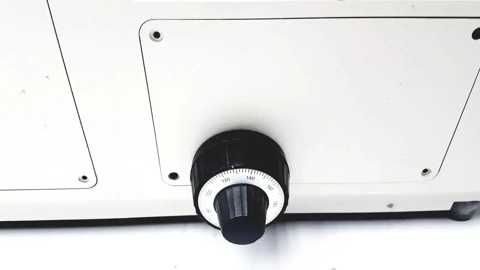 Black rotary dial with white numbers on white panel of axiovert 35 inverted phase contrast microscope control