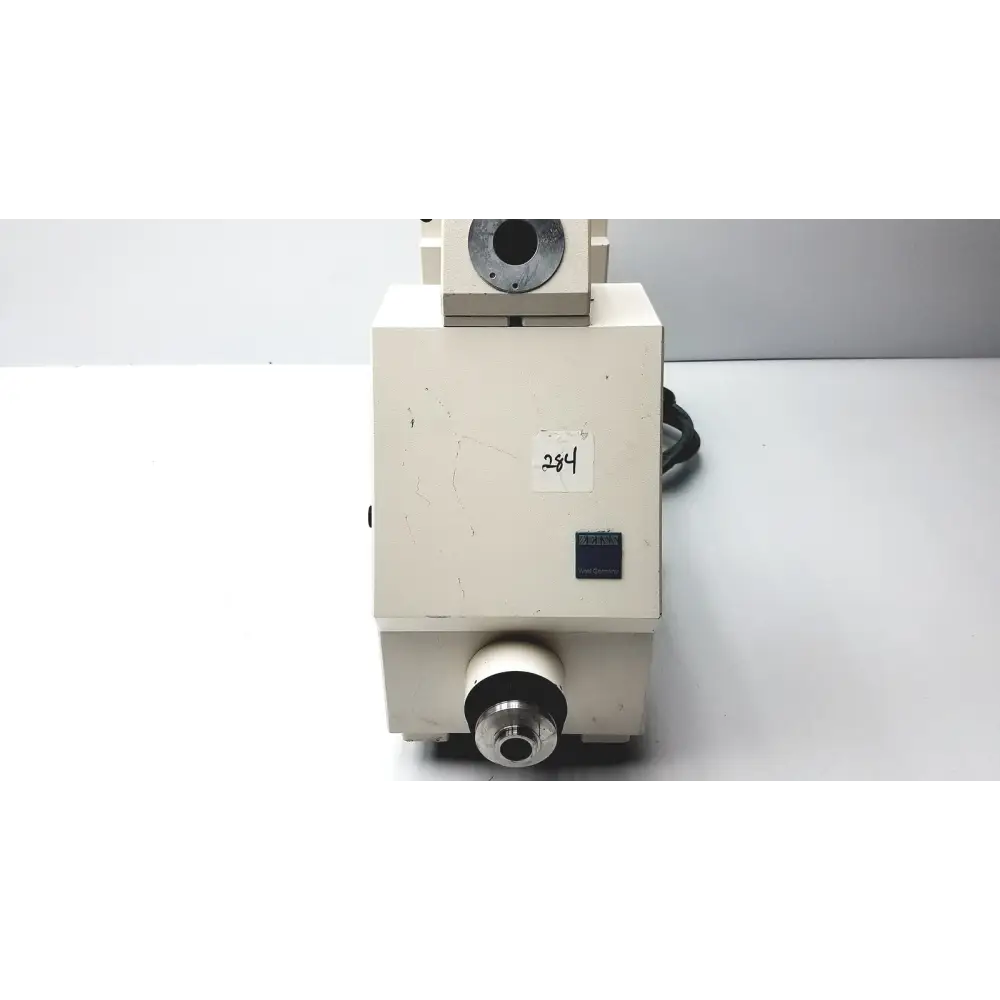 Beige nikon microscope with a black cable and silver metallic components.