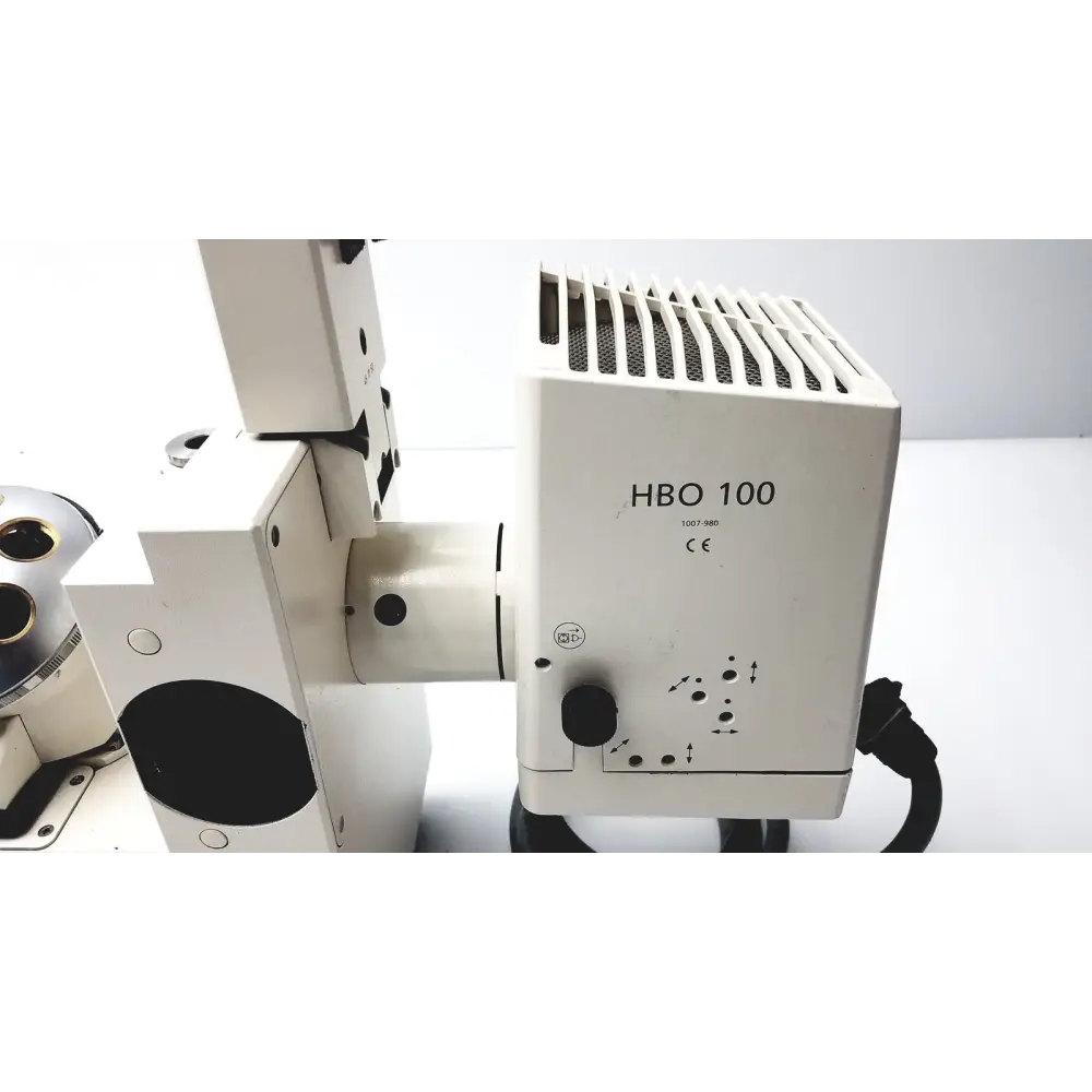 White hbo 100 microscope component with a vented top and black cable.
