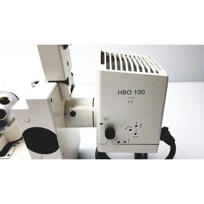 White hbo 100 microscope component with a vented top and black cable.