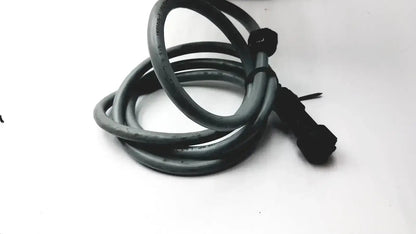 Black coiled cable with black connector end at the back of an Axiovert 35 inverted phase contrast microscope