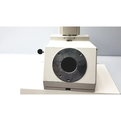 Beige metal microscope stage with a circular black mounting plate and four screw holes.