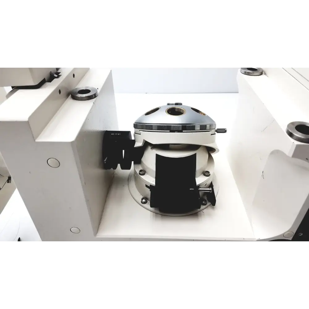 Silver and white industrial machine component with black clamps