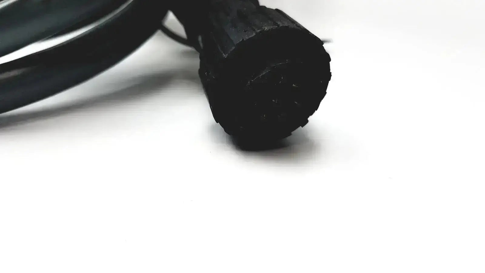 Black rubber-coated electrical cable with textured ribbed connector end for axiovert 35 inverted phase contrast microscope