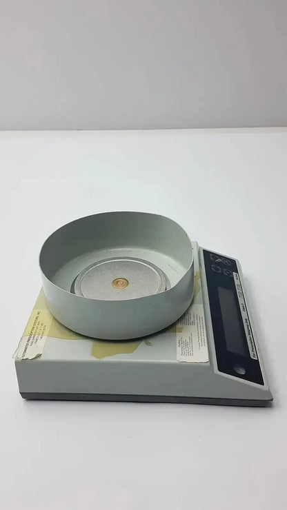 Gray baker universal g-box12-33i digital scale with circular weighing platform and black control panel for prescription weighing