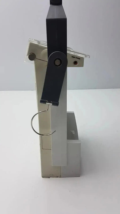 Black and beige plastic clamp with metal hook for bard criticore fluid output and temperature monitor 000002n